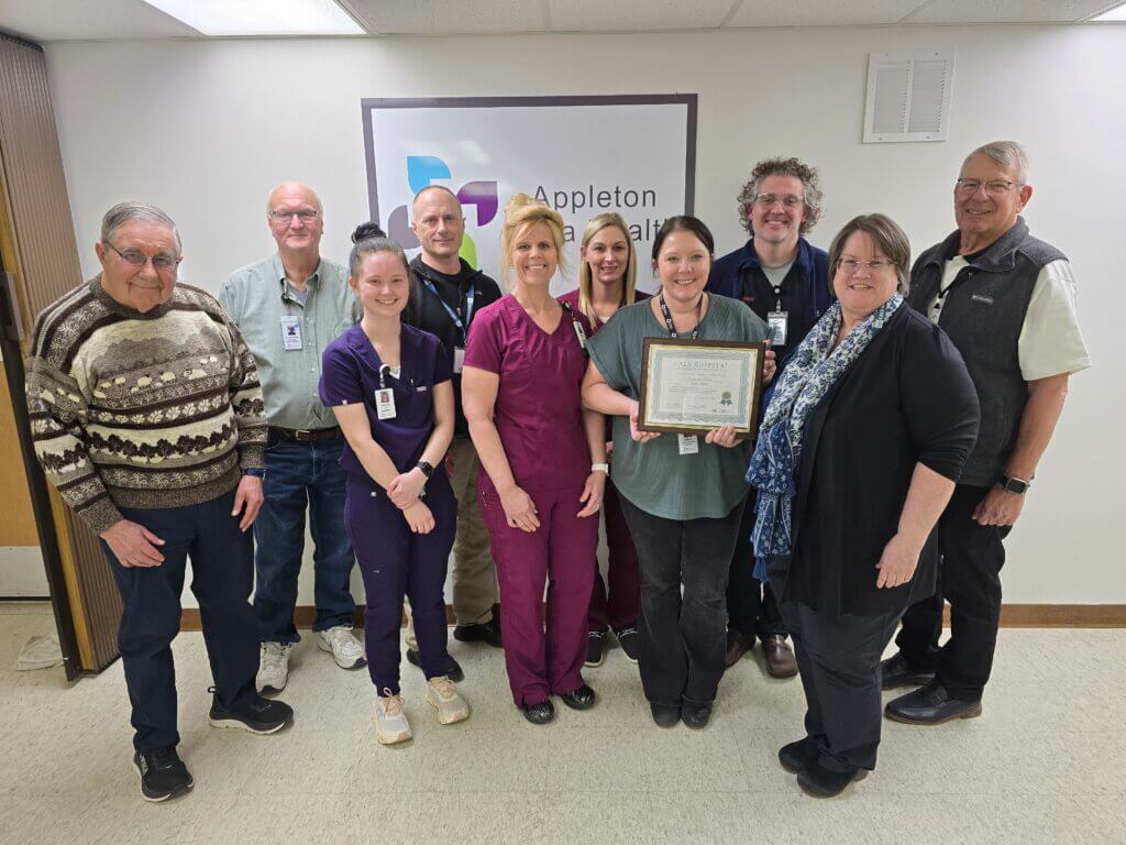 CALS Executive Director Ann Gihl, Education Manager Dan Johnson, and Program Founder Darrell Carter present the CALS Hospital Award to Appleton Area Health Staff.