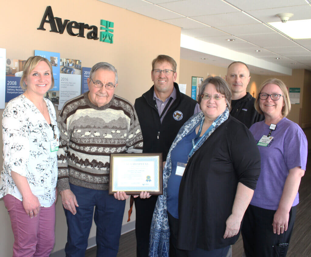 CALS Executive Director Ann Gihl, Education Manager Dan Johnson, and Program Founder Darrell Carter present the CALS Hospital Award to Avera Granite Falls staff and leadership.
