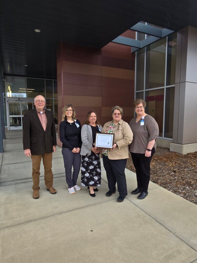 CALS Executive Director Ann Gihl and Board Member Paul Van Gorp present the CALS Hospital Award to CentraCare Melrose staff and leadership.