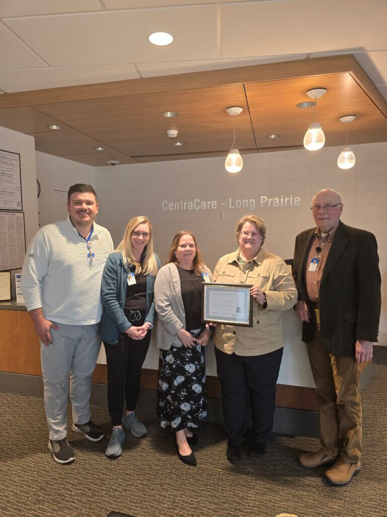 CALS Executive Director Ann Gihl and Board Member Paul Van Gorp present the CALS Hospital Award to CentraCare Long Prairie staff and leadership.